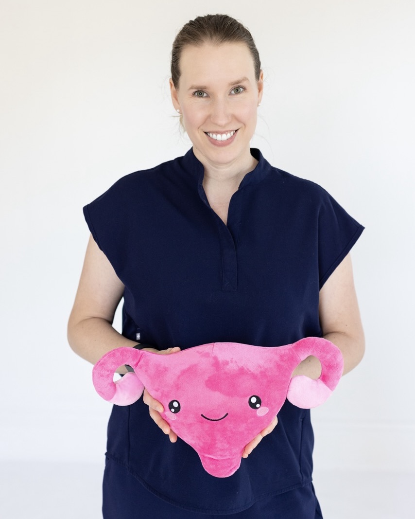 Dr. Carlson holding a plush uterus.
